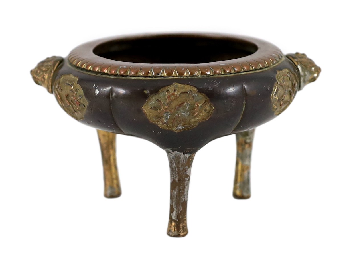 A Chinese Imperial copper alloy censer, ding, 18th century, 12cm wide 7cm high, ring handles and cover lacking, some wear.